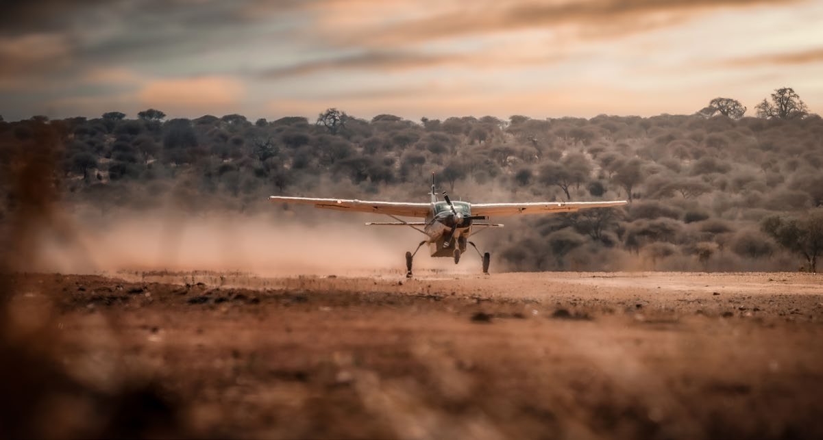 Fly-in safari aircraft landing on a bush airstrip
